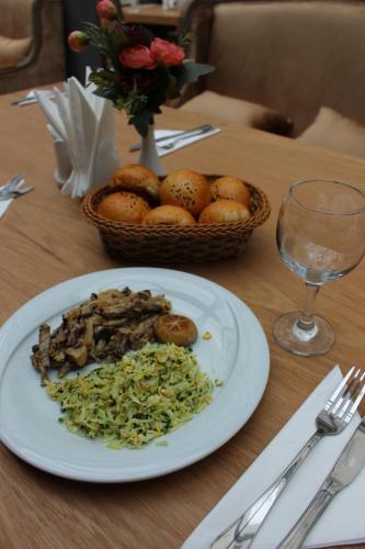 a plate of food on a table with a basket of food at Sky Hotel Baku in Baku