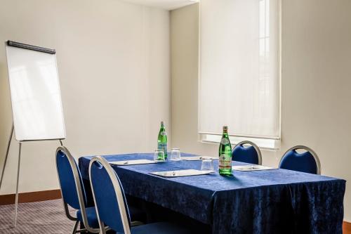 a blue table with chairs and two bottles on it at Eurostars Roma Aeterna in Rome