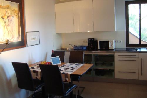 - une cuisine avec une table et un ordinateur portable dans l'établissement Kallista 2, à San-Giuliano