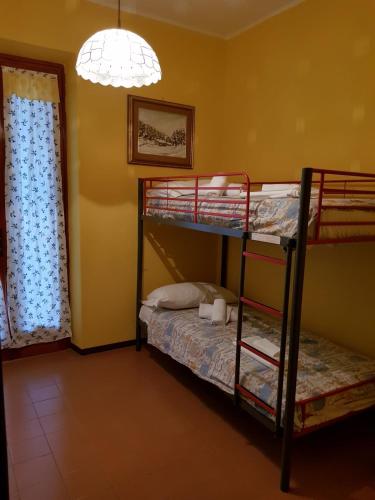 a room with two bunk beds and a lamp at Villa Patrizia in Torri del Benaco