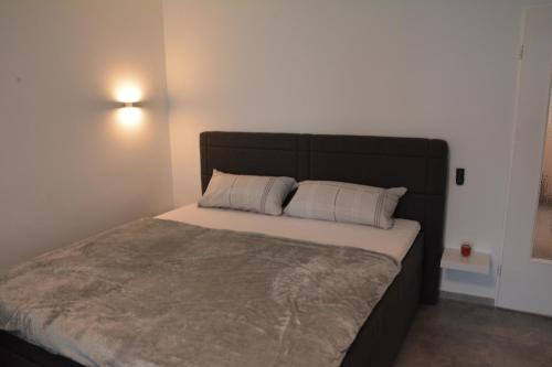 a bedroom with a large bed with white pillows at Ferienwohnung Ohanna in Bad Harzburg