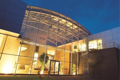 a large glass building with a staircase in front of it at Let's Meet Elewijt in Elewijt