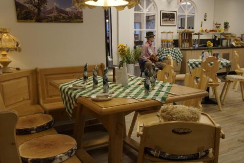 a man sitting at a table in a room with a table sidx sidx at Hotel Edel Weiss in Bremen
