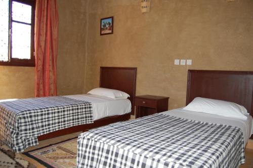 Postel nebo postele na pokoji v ubytování Auberge Amellagou