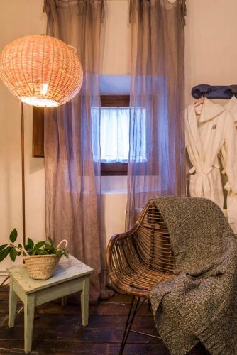 a room with a chair and a table and a window at Mas el Mir in Ripoll