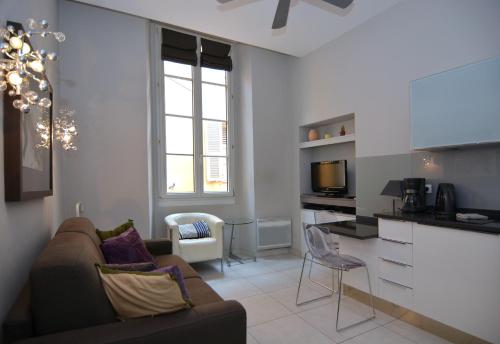 un salon avec un canapé et une cuisine dans l'établissement Je suis à Nice, à Nice