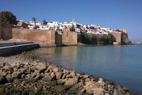 a town on a hill next to a body of water at Médina Flat in Rabat