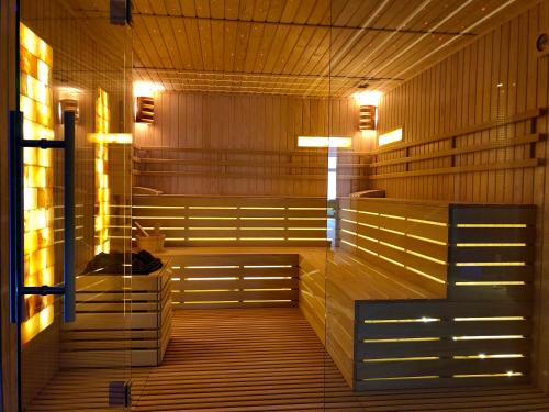 a sauna with benches and lights in a room at Hotel Complex Turistic Magura in Măgura