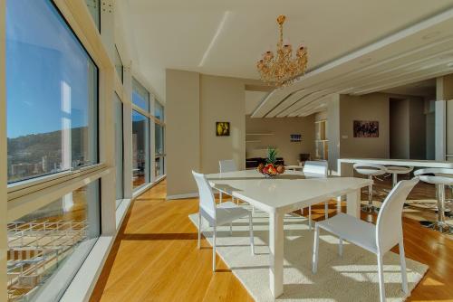 a dining room with a white table and chairs at Hotel Tre Canne in Budva