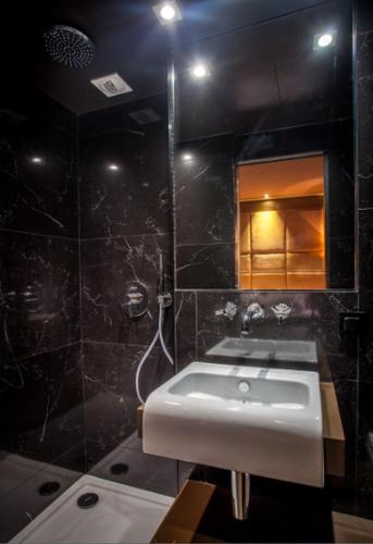 a bathroom with a sink and a mirror at Hotel Armoni Paris in Paris