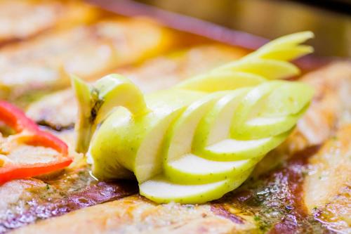 a close up of a piece of food with vegetables at Hotel Biarritz in Gandía