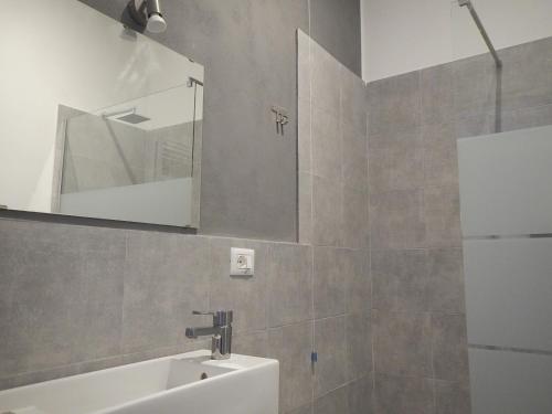 a bathroom with a sink and a mirror at La Pergola Private Parking in Vezzano Ligure