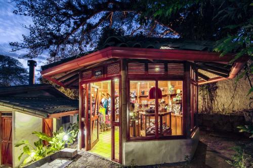 a small house with a glass door at Finca Rosa Blanca Coffee Farm and Inn in Heredia