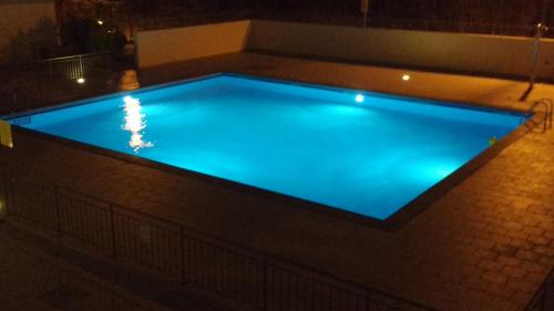 a swimming pool lit up at night at Vista Montagna in Caulonia Marina