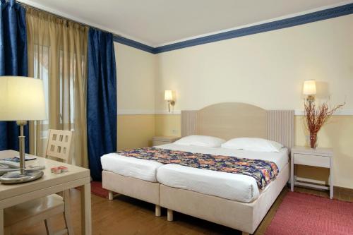 a hotel room with a bed and a desk at Amadria Park Apartments Šibenik in Šibenik
