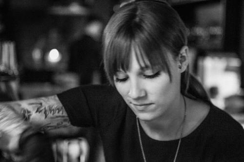 a woman with a tattoo on her arm at Hafen 17 Hotel Küche Bar in Kehl am Rhein