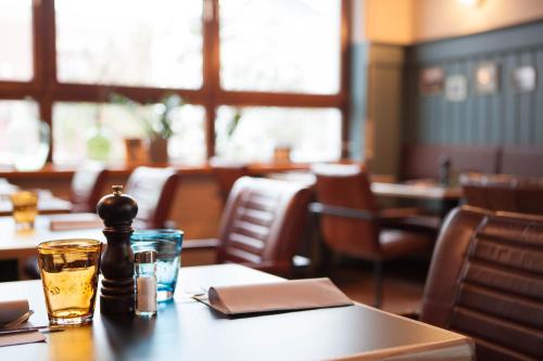 a table in a restaurant with a drink on it at Hafen 17 Hotel Küche Bar in Kehl am Rhein