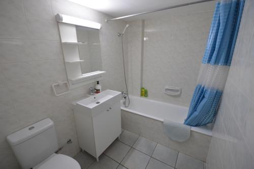 a bathroom with a toilet and a sink and a shower at Krasas Beach Flats in Larnaka