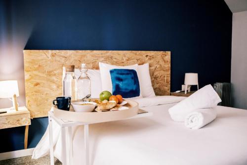 a bed with a tray of fruit and drinks on it at B&B El Mercat in Valencia