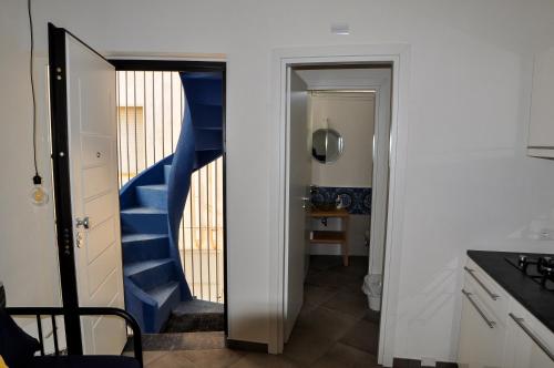 a hallway with a blue staircase in a room at Anita & Garibaldi in Marsala