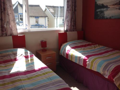 Krevet ili kreveti u jedinici u okviru objekta Lindisfarne Holiday Apartments - Families & Couples Only