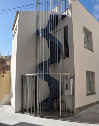 a staircase painted on the side of a building at Anita & Garibaldi in Marsala