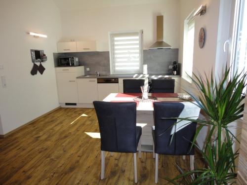 a kitchen with a table and chairs in a room at Gasthof Reiterstuben in Hoßkirch