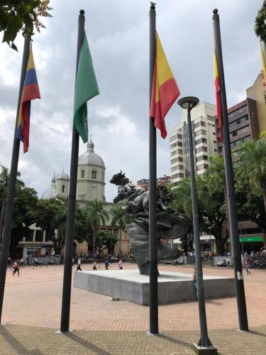 a group of flags in front of a statue at Hotel Condina Pereira in Pereira