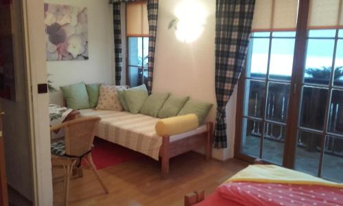 a living room with a couch and a window at Farma Zdrowia in Znamirowice