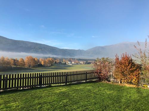 a fence in a yard with mountains in the background at Haus Sonnenweg in Mariapfarr