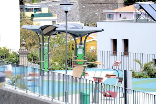 a park with a playground with a pool at Mericia's Gorgeous View in Funchal