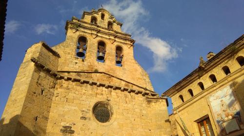 a building with a clock tower on top of it at El Racó de les Grases in Horta de San Joan