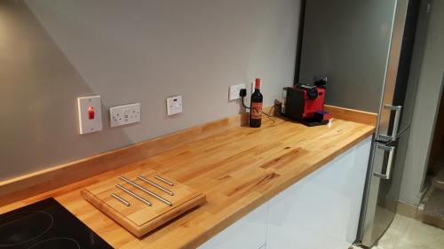 a wooden counter with a bottle of wine on it at Georgian 8 bed, 4 room, home from home in Derry Londonderry