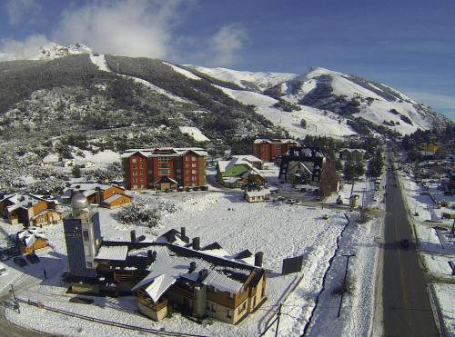 a town covered in snow with a mountain in the background at Galileo Boutique Hotel in San Carlos de Bariloche