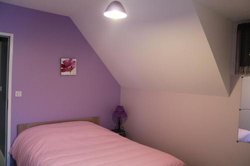 a bedroom with purple walls and a bed at Les coquelicots in Luz-Saint-Sauveur