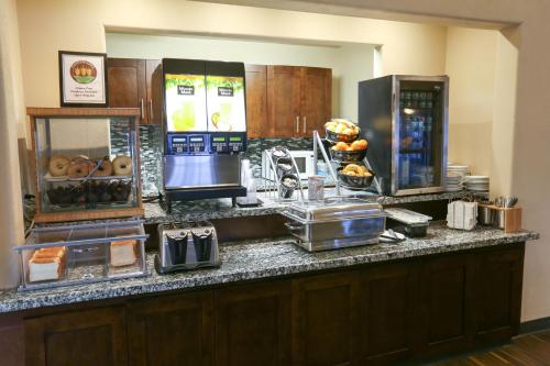 a kitchen with a counter with some food on it at Days Inn by Wyndham Calgary Airport in Calgary