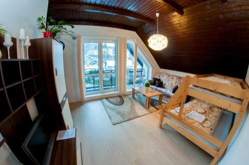 un soggiorno con divano e una grande finestra di Penzion Riverside a Vrchlabí