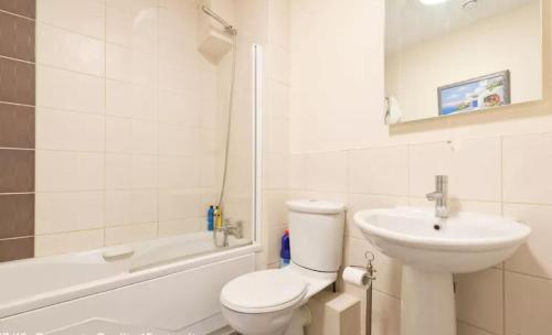 a bathroom with a toilet and a sink and a bath tub at Dublin Corporate Apartment in Lucan