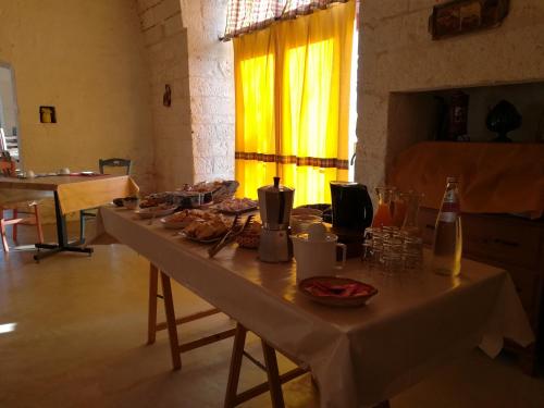 a long table with food and drinks on it at Masseria Ferri in Ostuni