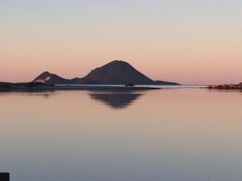 an island in the middle of a large body of water at Thornton Beach Holiday park in Thornton
