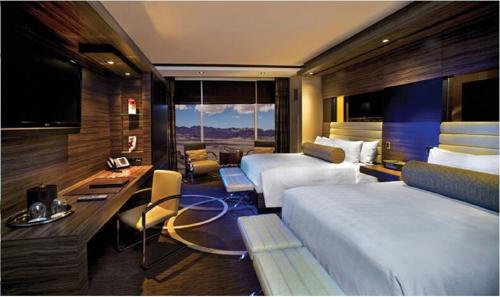 a hotel room with two beds and a desk at M Resort Spa & Casino in Las Vegas