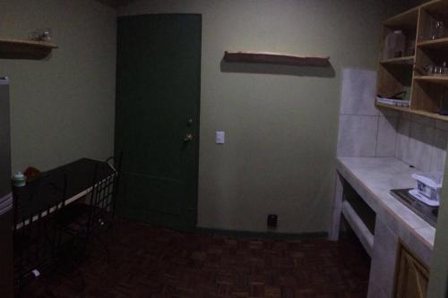 a room with a green door in a kitchen at Beautiful Apartment San Jose Downtown South in San José