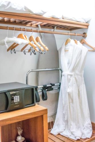 a robe hanging on a rack next to a tv at Pullman Reef Hotel Casino in Cairns