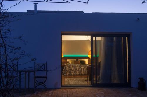 a blue room with a bed and a sliding glass door at Monte Do Malhao - Art, Eco & Spa in Castro Marim