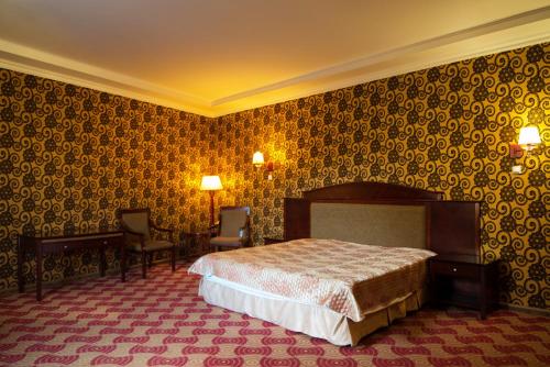 a hotel room with a bed and a table and chairs at Rubin Hotel Complex in Yakutsk