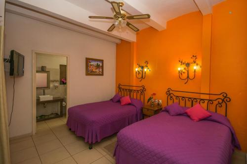 Кровать или кровати в номере Hotel Posada Santo Niño