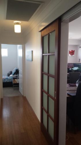a hallway with a door and a room with a bed at Carpe Diem South #3 in Busselton