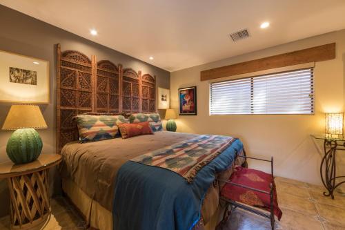 a bedroom with a bed and a table and a window at A Sunset Chateau in Sedona