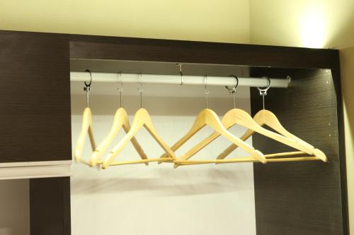a group of baseball bats hanging from a rack at Eclat Suites Hotel Boutique in Villa Mercedes