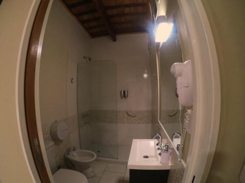 a bathroom with a sink and a shower and a toilet at Eclat Suites Hotel Boutique in Villa Mercedes